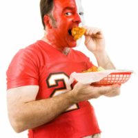 Sports fan eating fried food