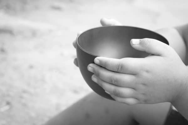 child holding empty bowl