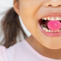 Children with bad teeth and eating sugar candy. Oral and bone health.